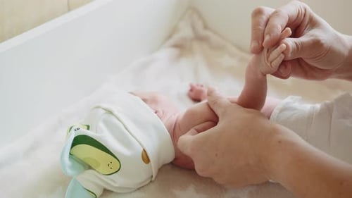 Close Up of Parent Exercising Infant's Arm