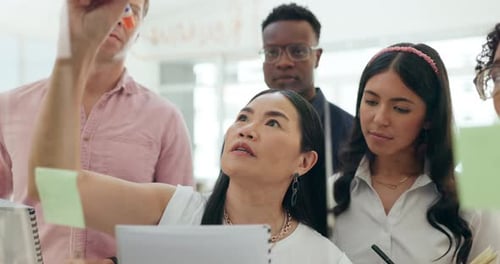 Diverse Team Brainstorming Ideas at Office Whiteboard
