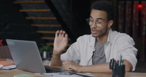 Young Adult in Video Conference at Modern Workplace