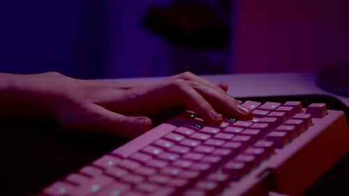 Close up of fingers of a man pressing buttons of a computer keyboard