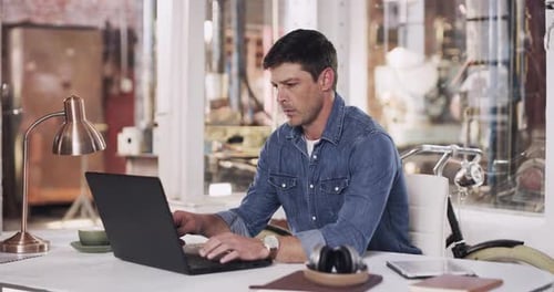 4k video footage of a young man taking a break at his desk in a welding workshop