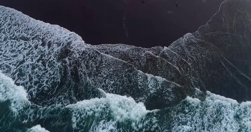 Top View of Ocean Waves Creating Natural Patterns on Shore