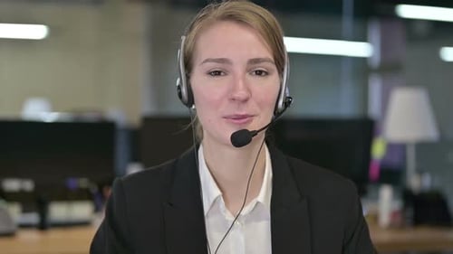 Friendly Woman Talking with Headset in Office