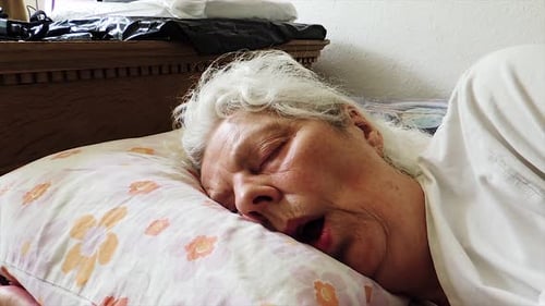 Sleepy Elderly Lady Sleeping in Bed - Handheld Steady Shot