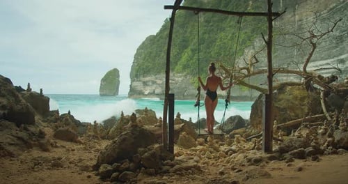 Swing facing the majestic sea cliffs. The ocean's roar accompanies a peaceful swing ride, breathtaki