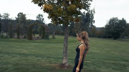 4k shot of beautiful young women running and jogging outdoor in a park at sunrise with cloudy sky