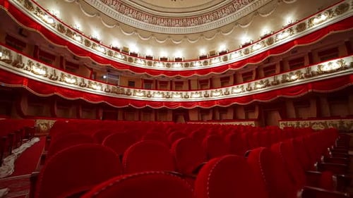 Rows with red chairs in beautiful theater hall. No audience at lockdown time.