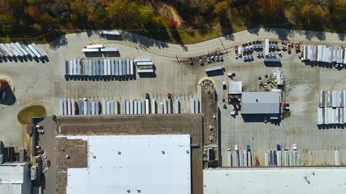 Aerial View of Large Commercial Loading Bay with Many Delivery Trucks Unloading and Uploading Retail