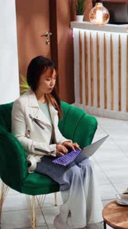 Vertical Video Traveler Solving Tasks on Laptop Upon Her Arrival at Hotel