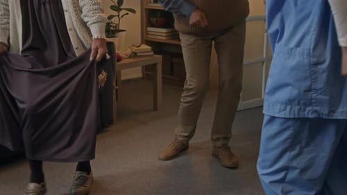 Seniors and Young Adults Dancing Together Indoors
