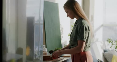 Young Woman Making a Sandwich in Kitchen