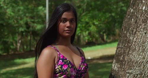 Dressed in a gorgeous outfit, a young girl of East Indian origin has a great time at the park.