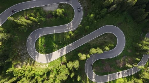 Winding Mountain Road Offers Stunning Views of Dense Forest and Sharp Curves