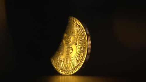 Golden Bitcoin Spins on a Dark Surface