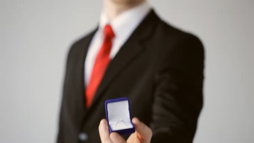 Man in Suit Presents Engagement Ring