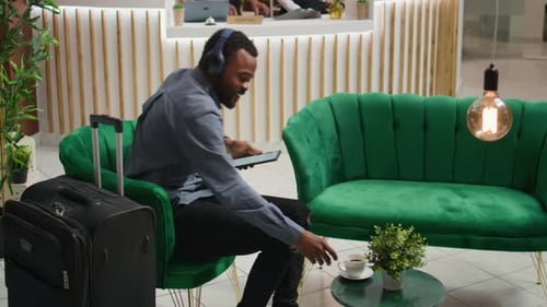 Man Using Tablet in Elegant Hotel Lobby