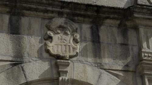 Old Weathered Stone Door Arches With A Carved Coat Of Arms At The Top