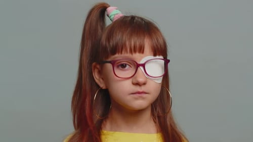 Child Wears Eye Patch and Glasses Close Up