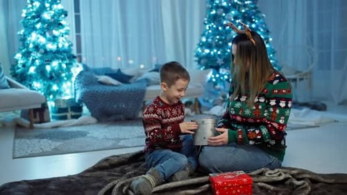 Mother and Child Opening Gifts at Christmas Time