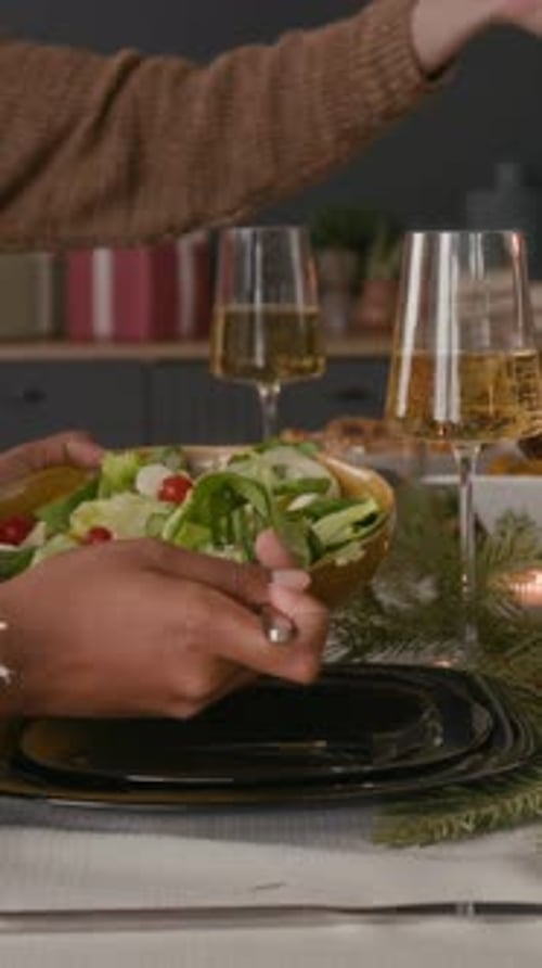 Serving delicious salad at holiday table setting