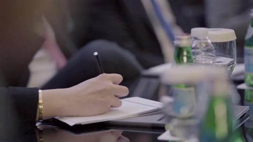 Business Meeting Attendees Taking Notes