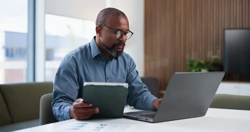 Businessman, typing and tablet in office with laptop for data entry, financial planning and audit