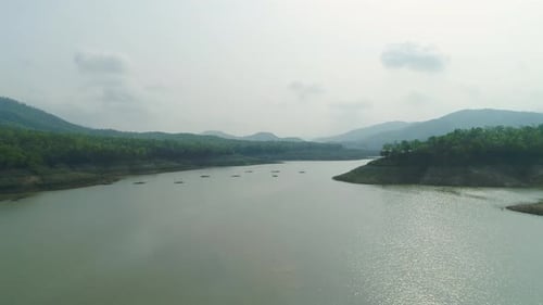 4k Aerial View of Tranquil River Surrounded by Mountain and Clear Sky in Thailand