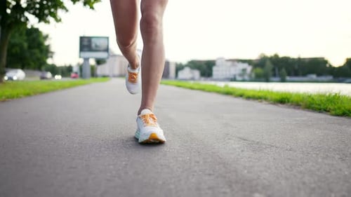 Legs of Woman in White Sneakers Running on Walkway in City Park Near Lake Skinny Sportive Young