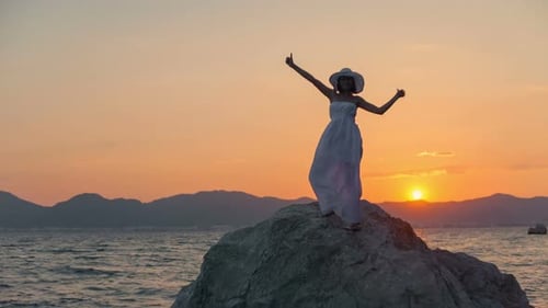 Happy Woman on Windy Beach at Sunset Background in White Dress Shows Like