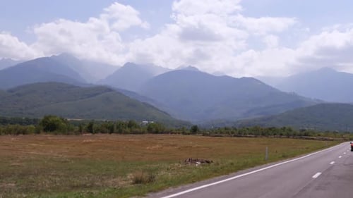 Cinematic View of the mountains from the car window while driving.Summer trip.