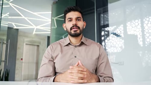 Webcam view. Businessman watching video call online conference looking at camera at laptop computer