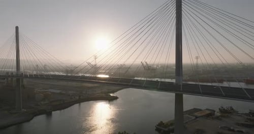 a bridge over water with a body of water and a city