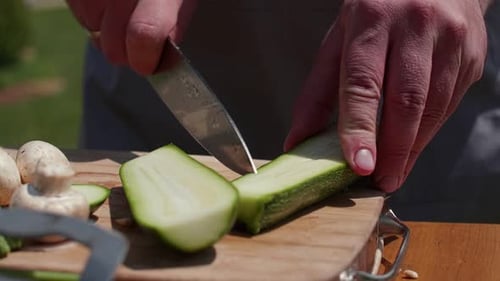 Close Up Hands Chop Vegetables Outdoors