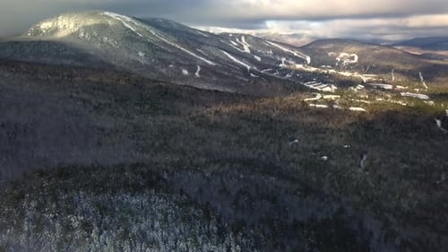 Aerial view of mountain range with ski village.