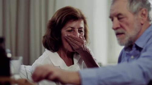 Senior Woman Taking Medicine with Support from Man