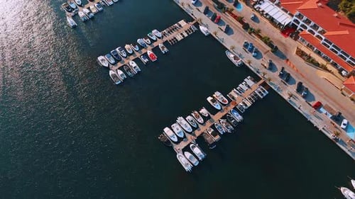 Aerial view of marina with yachts and coastline city.