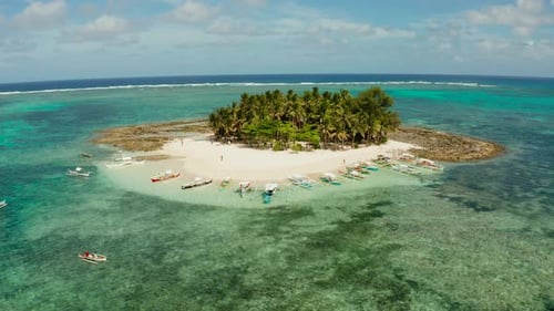 Tropical Guyam Island with a Sandy Beach and Tourists