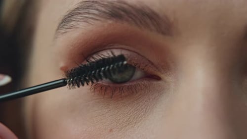 Woman Applying Mascara in Extreme Close-Up