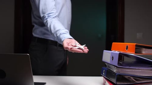 Man in Office Holding Airplane Model in Palm Concept of Airplane Flights