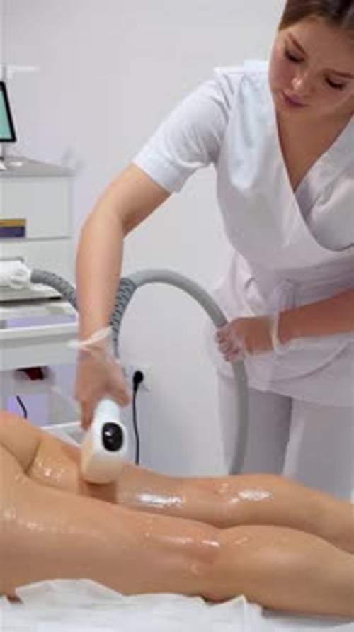Woman Beautician Removes Hair on Beautiful Female Skin Using Safe Depilation Laser at Hospital Room