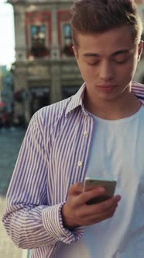 Portrait Young Serious Man Walk on Street Use Phone Look Around Sunlight Cute Work Mobile Gadget