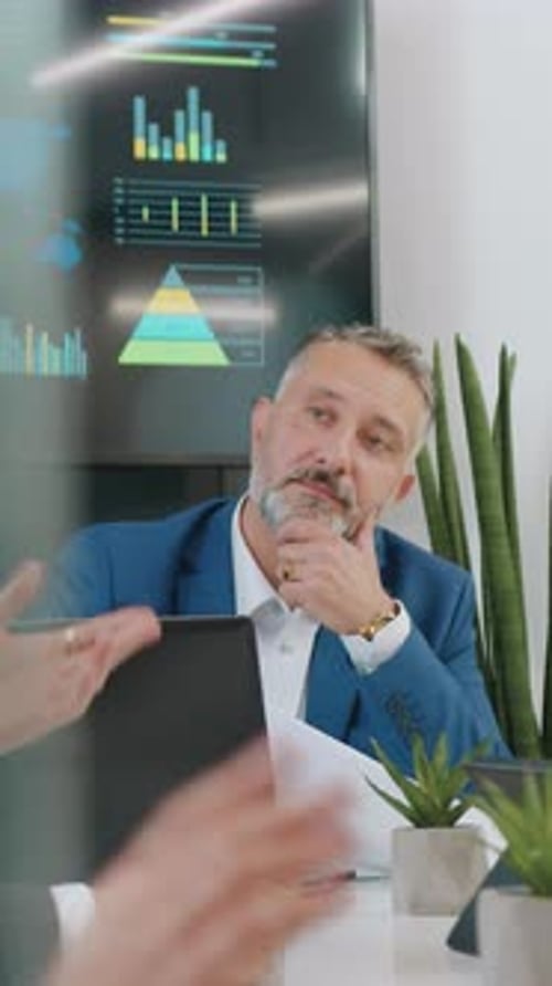 Man Thinking About Data in Modern Office Meeting