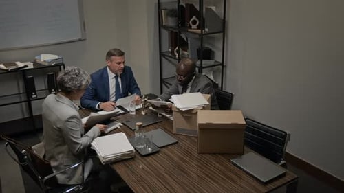 Team of Defense Attorneys Researching Paperwork for Lawsuit in Office