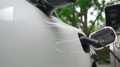 Closeup Progressive Concept of Electric Car Being Charged at Charging Station