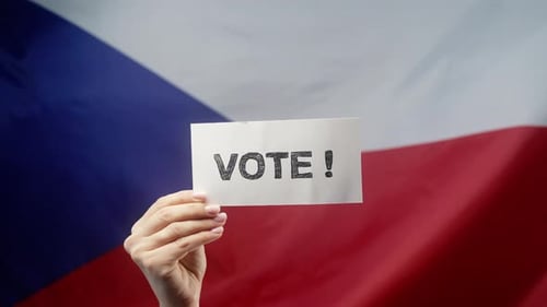 Hand Holding Sign to Vote with Flag Background