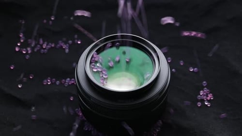 Camera Lens Filled with Magenta Colored Beads