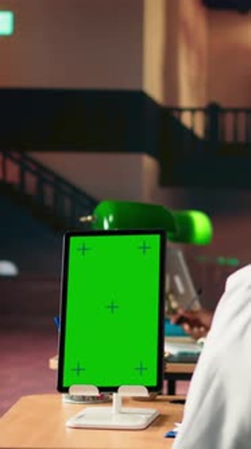 Vertical Video Young Man Medical Student Does Research for Exams Next to Chroma Key