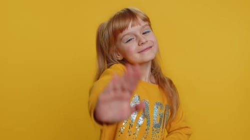 Young Toddler School Girl Kid Smiling Friendly Gesturing Hello or Goodbye Welcoming Waving Hands