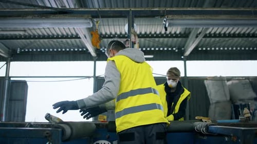 Workers sorting recycling in an industrial facility