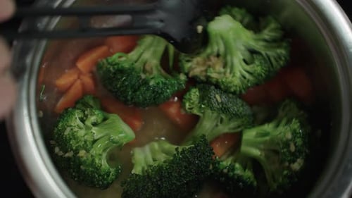 Steaming Broccoli and Carrots Cooking in a Pot